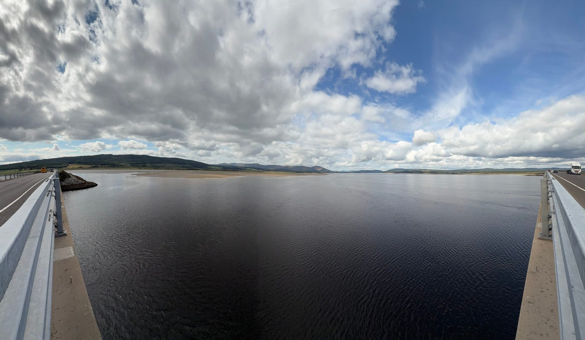 View across the Dornoch Firth from the Dornoch Firth Bridge under dramatic clouds.