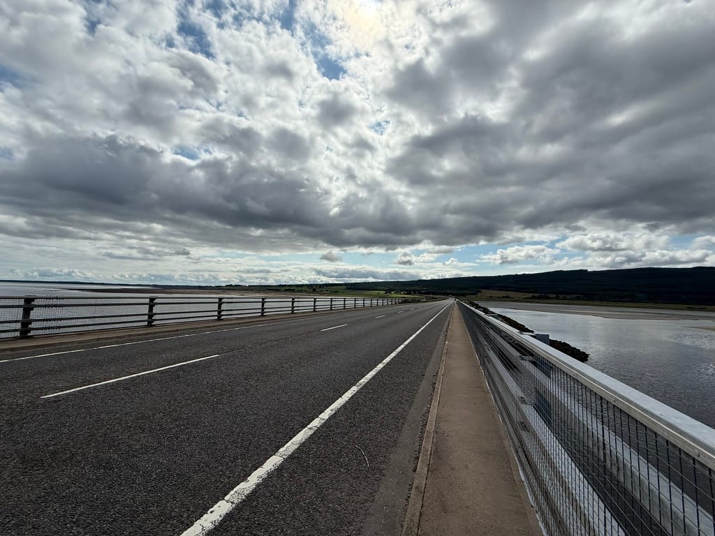 Dornoch Firth Bridge under dramatic clouds.
