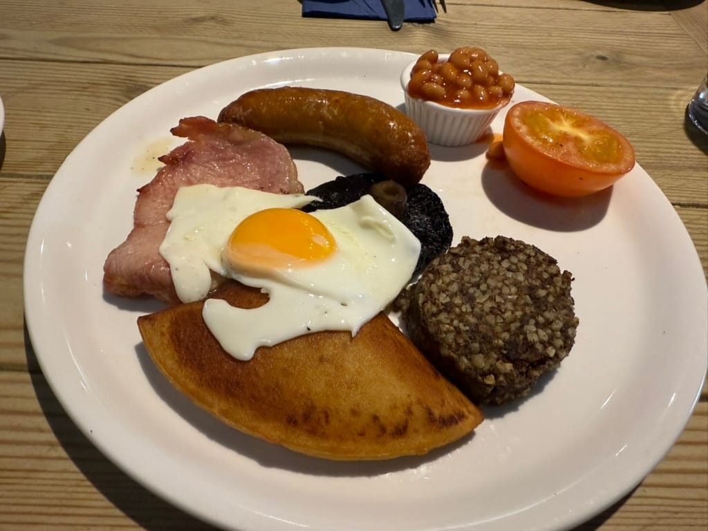 Full Scottish breakfast with egg, bacon, sausage and haggis.