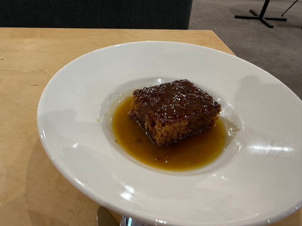 Sticky toffee pudding served with toffee sauce.