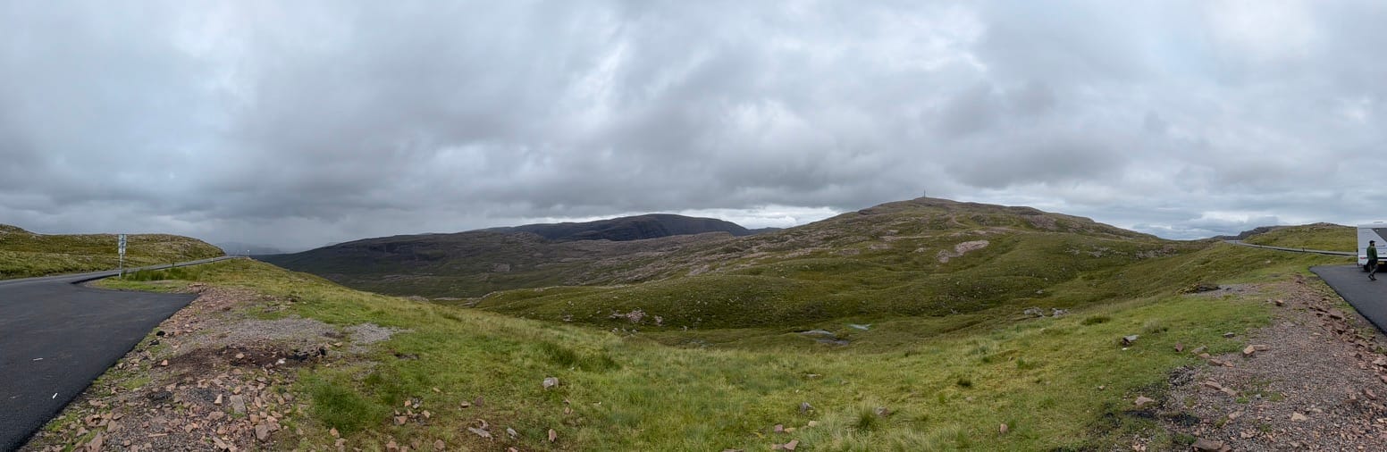 Panoramic Highland moorland beneath heavy clouds.