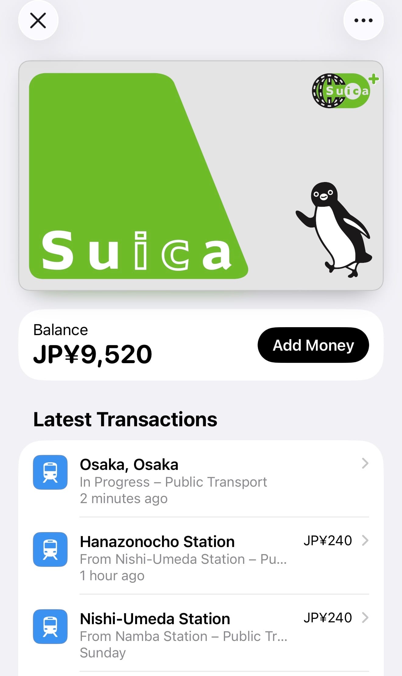 Digital Suica travel card displayed on a smartphone, showing a balance of ¥9,520 and recent public transport transactions in Osaka, including Nishi-Umeda and Hanazonochō.