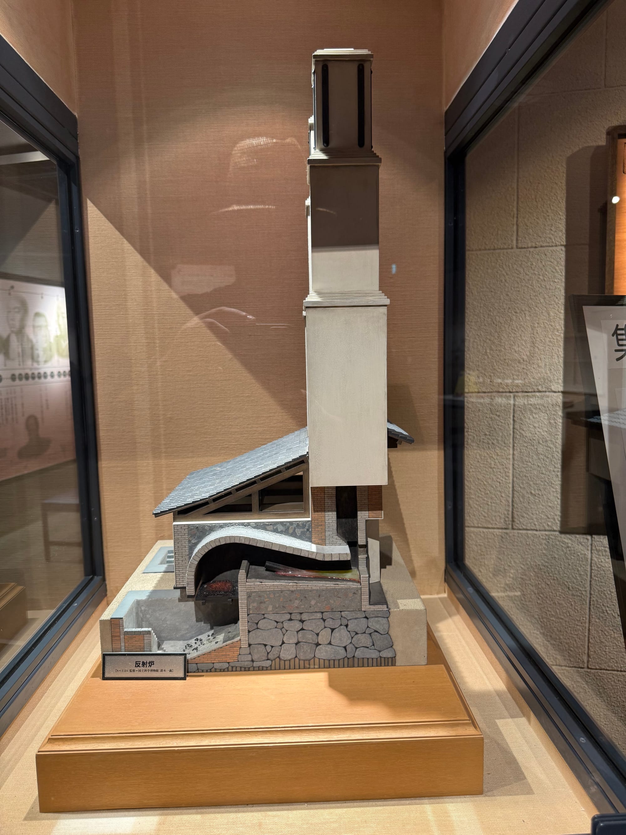 Scale model of a reverberatory furnace on display at the Museum of the Meiji Restoration in Kagoshima, showing its internal structure and tall chimney used for iron production.