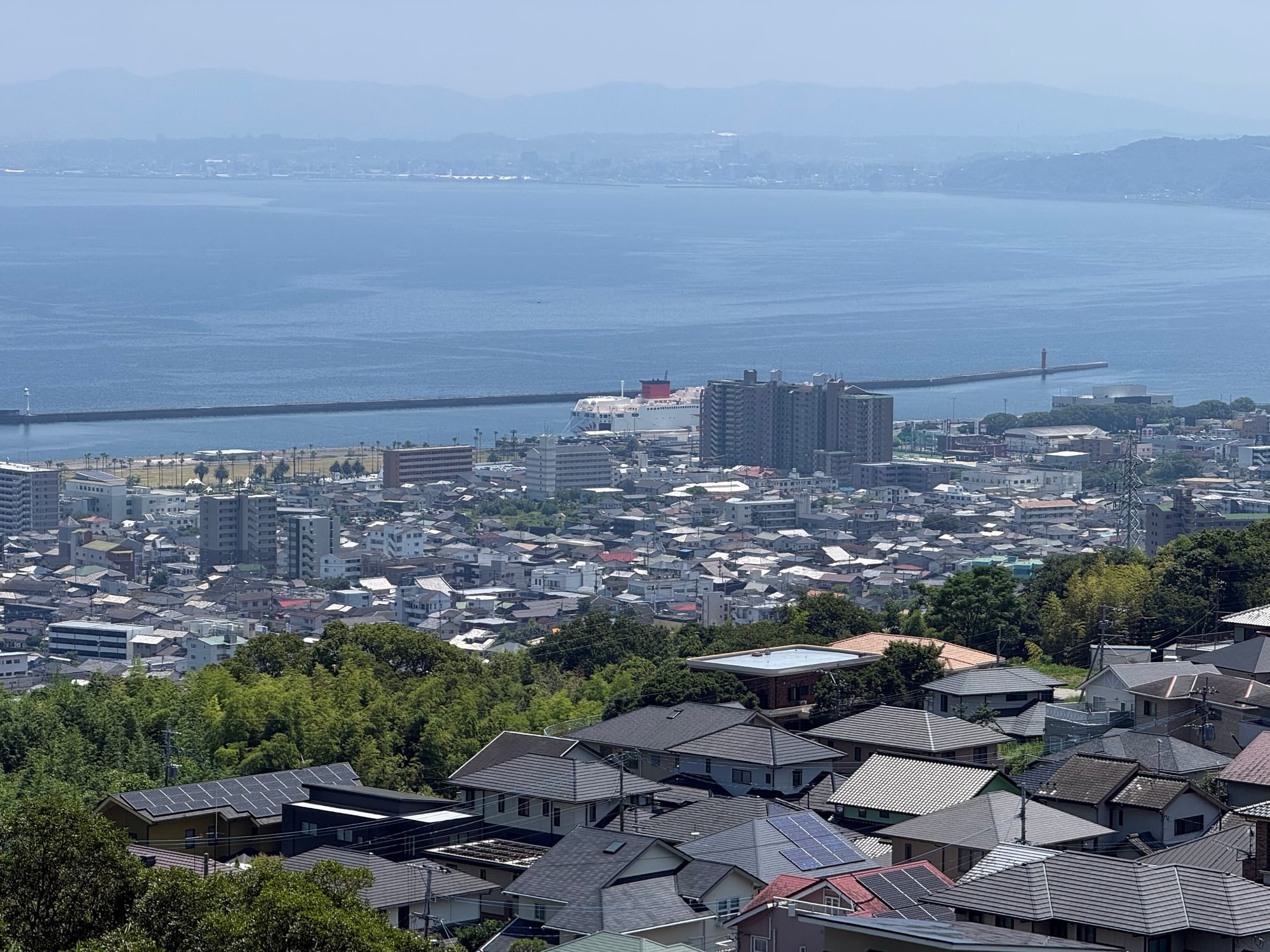The view from Kifune Castle overlooks Beppu's harbour and residential districts, with Beppu Bay stretching towards the distant mountains of northern Kyushu.