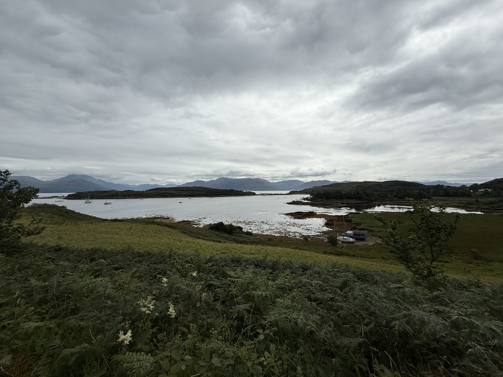 View across a tidal inlet on the Isle of Skye beneath dramatic clouds.