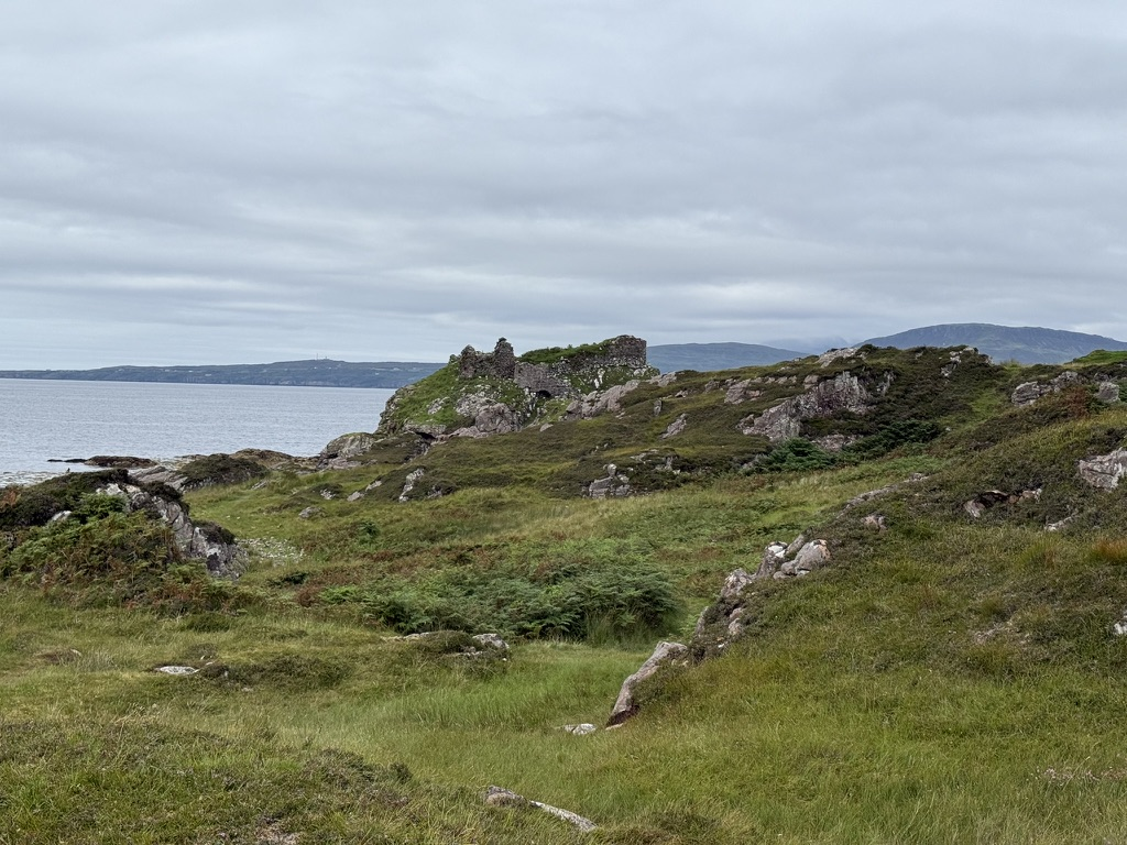 Ruins of Dunscaith Castle on a rocky coastal headland on the Isle of Skye.