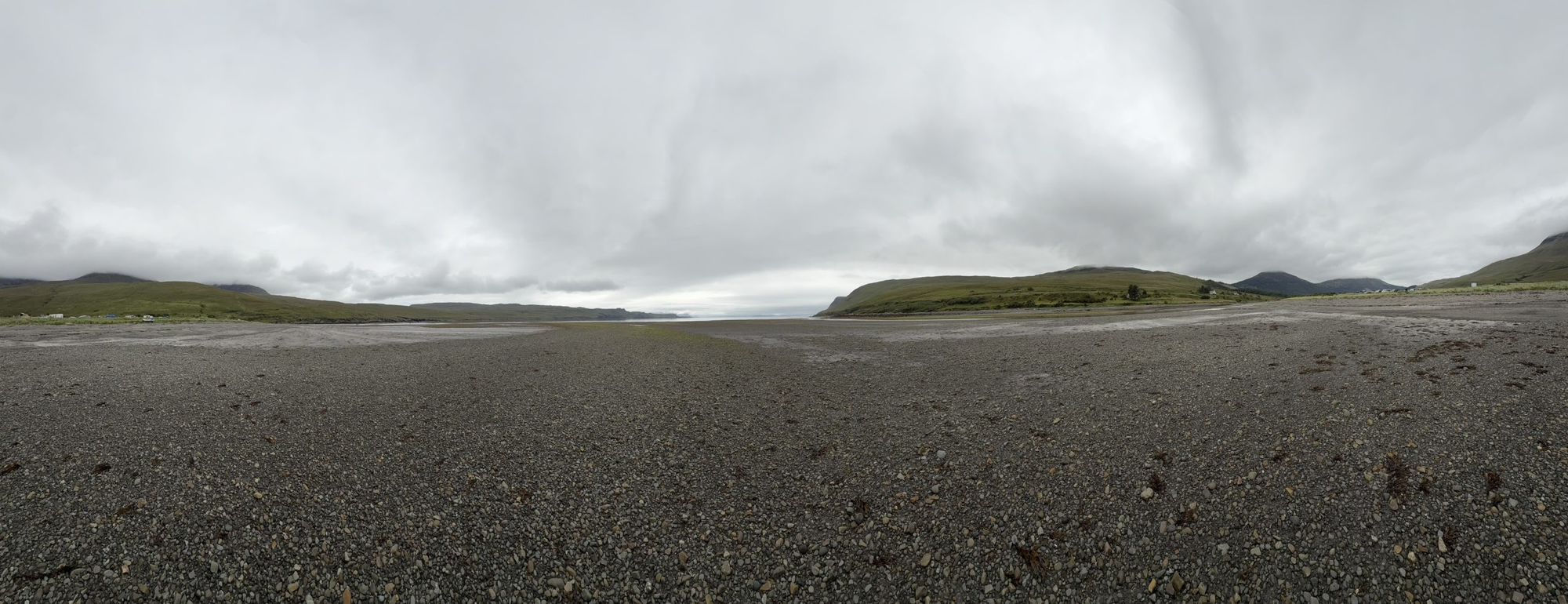 Panoramic view across the pebble beach and tidal flats at Glen Brittle on the Isle of Skye.