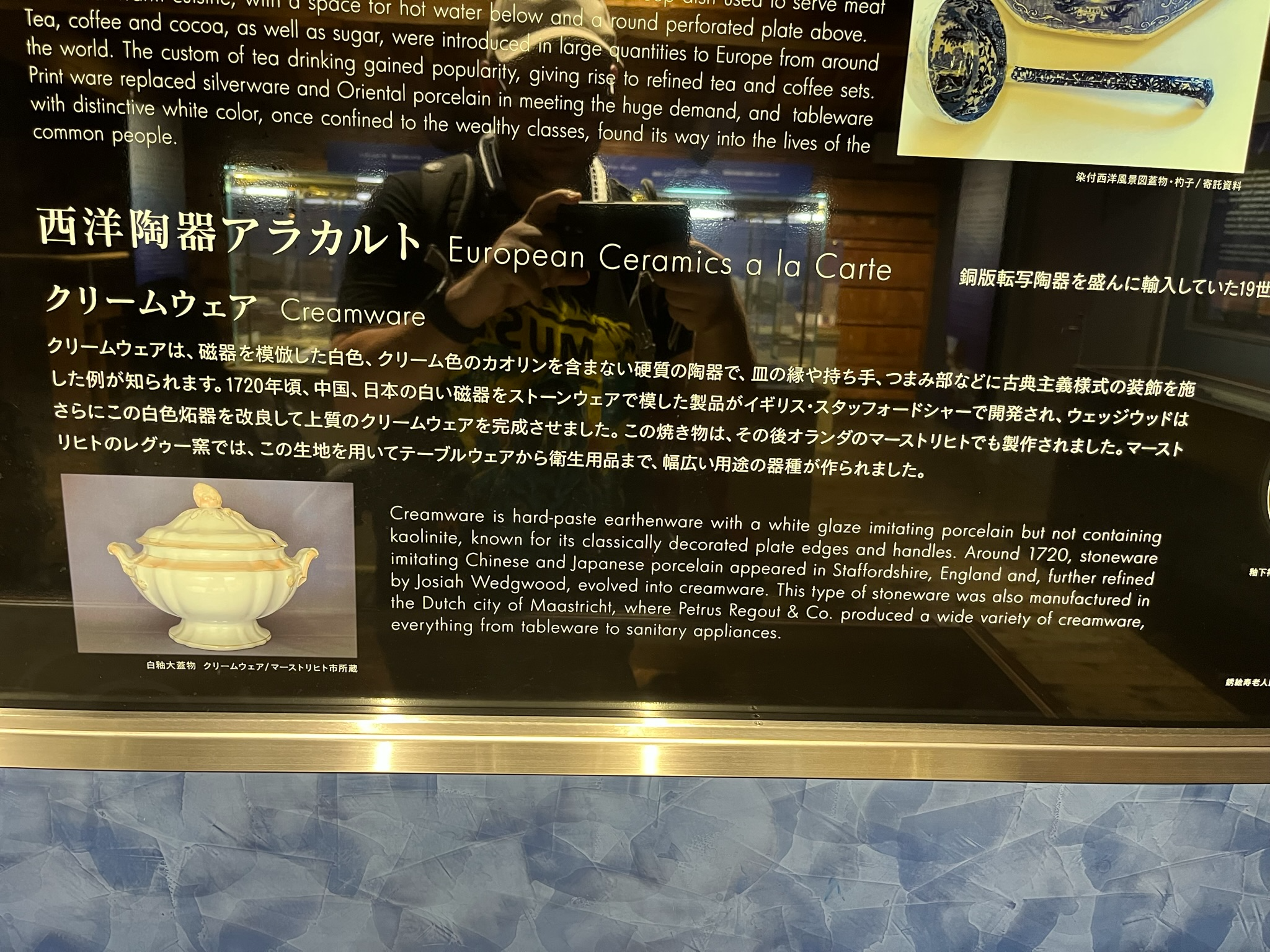 Museum display at Dejima explaining European creamware ceramics, featuring bilingual Japanese and English information panels and illustrations of imported tableware.