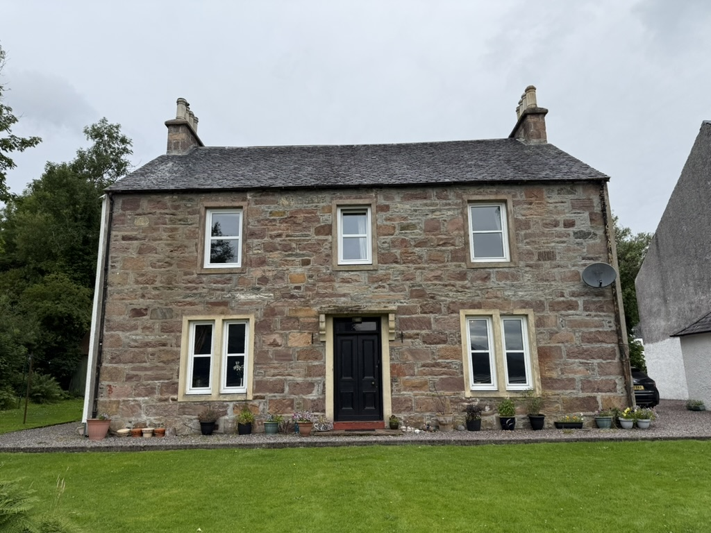 The Old Manse Guest House, a traditional stone building in the Scottish Highlands.