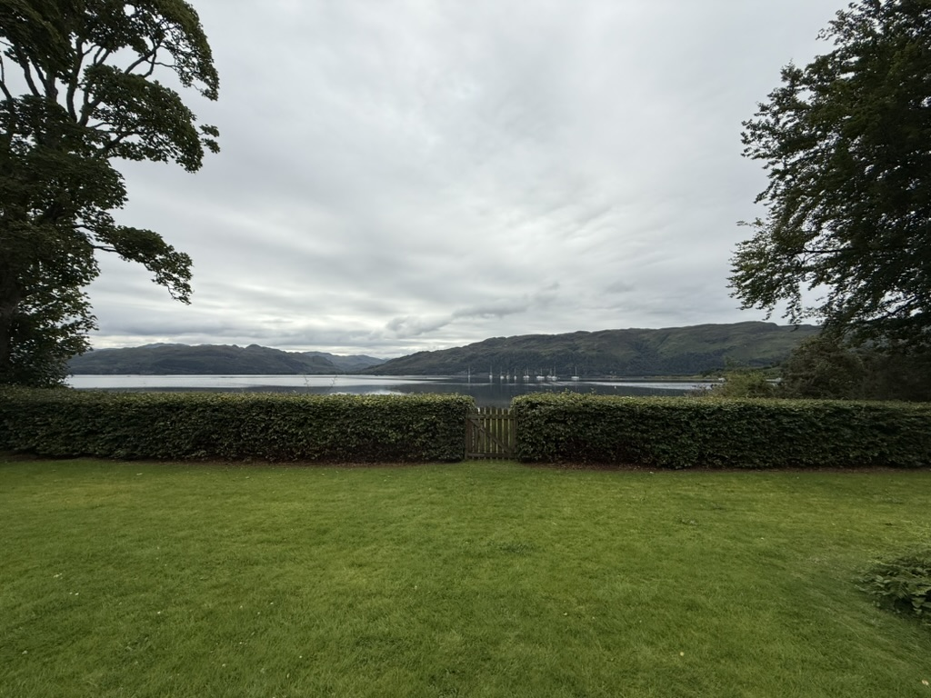 View from the Old Manse Guest House across a loch and surrounding hills.