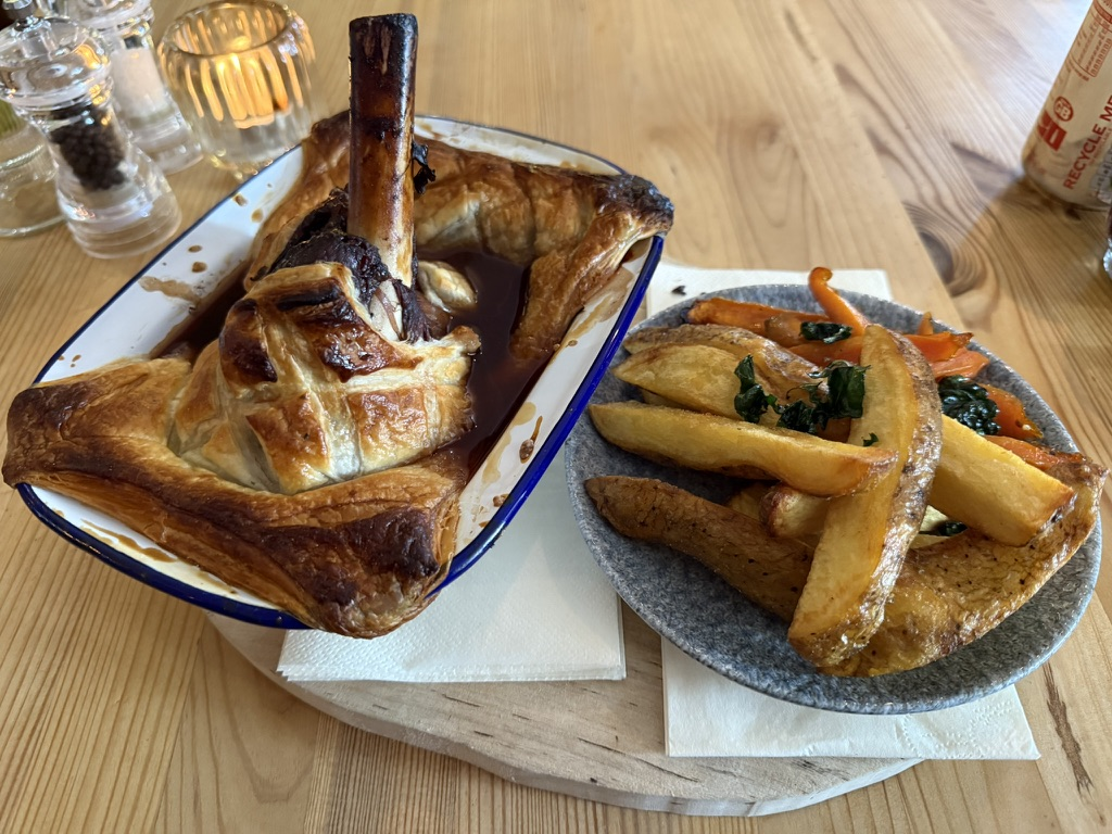 Lamb shank pie served with roast potatoes, vegetables and gravy at Lochcarron Bistro.