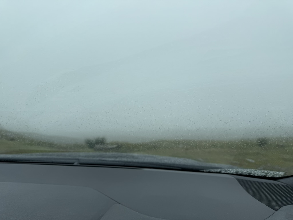 View through a rain-covered windscreen with near-zero visibility on the Bealach na Bà.