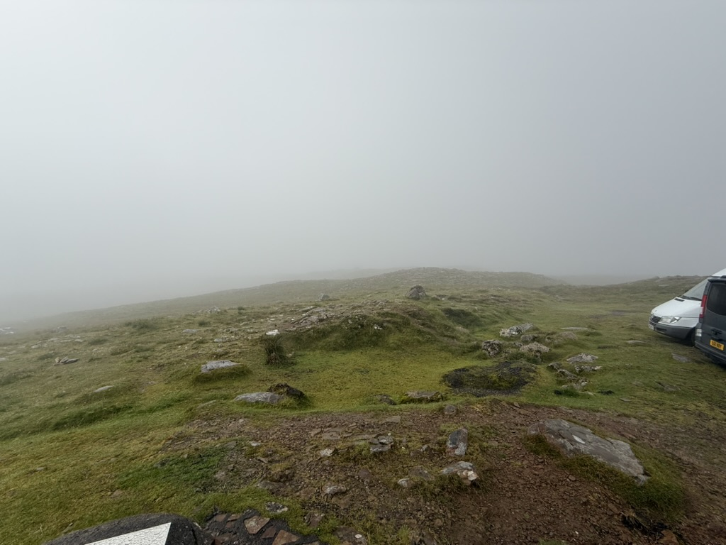 Bealach na Bà summit shrouded in thick fog and low cloud.