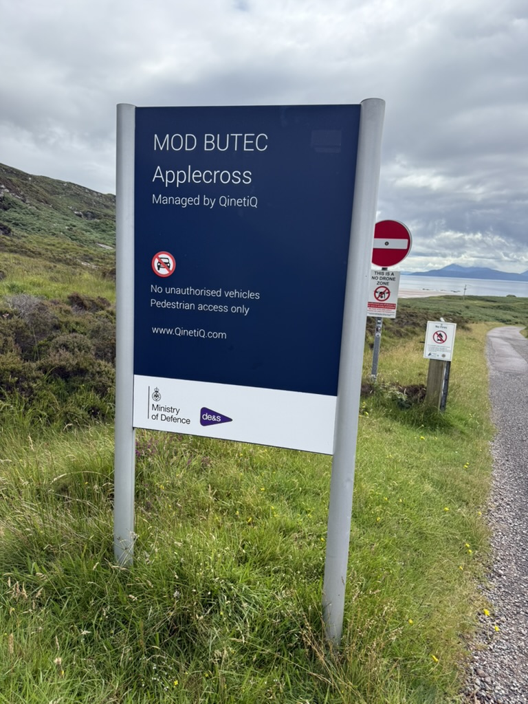 Ministry of Defence Applecross range sign beside a coastal path.
