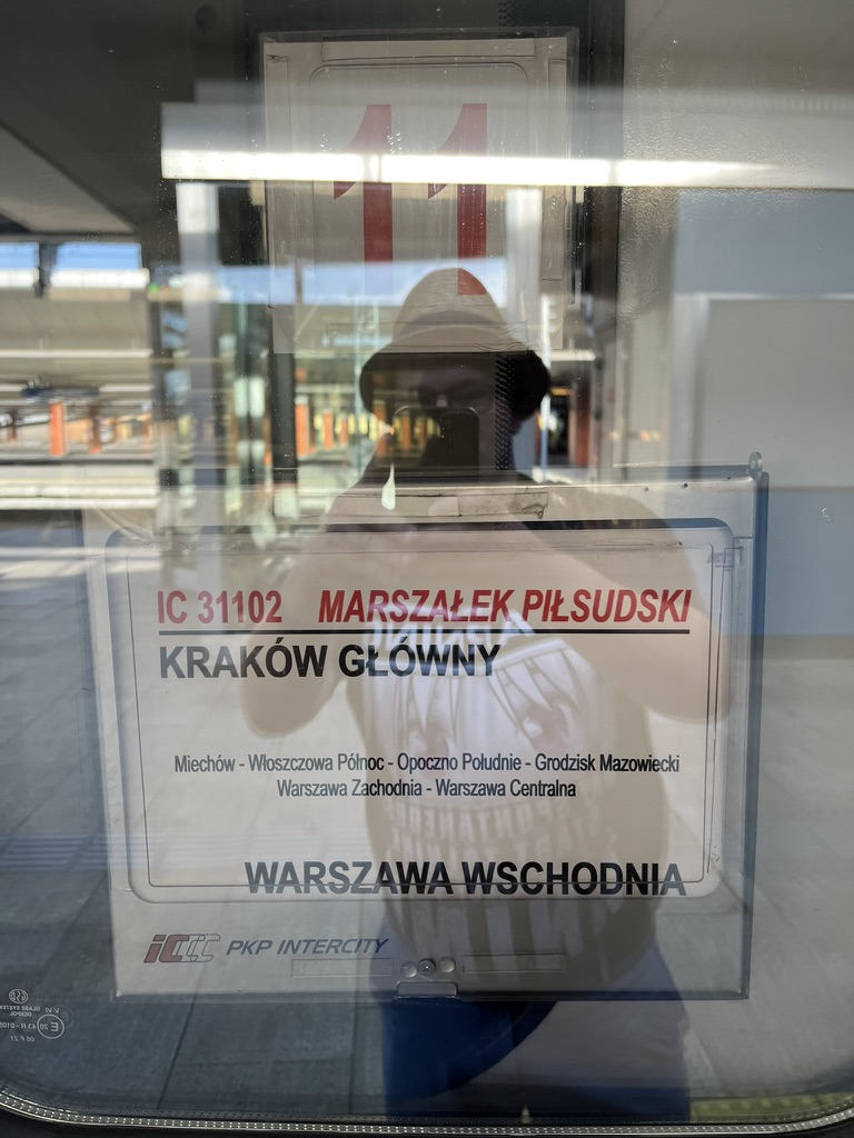 Destination board on a PKP Intercity train showing the route between Warszawa Wschodnia and Kraków Główny.