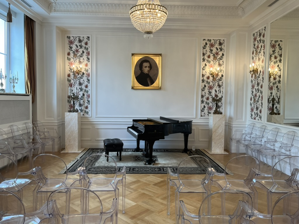 Grand piano beneath a portrait of Chopin in the Fryderyk Concert Hall, Warsaw.