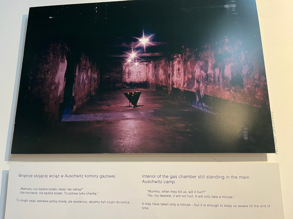 Exhibit at the Galicia Jewish Museum featuring a photograph of the gas chamber at Auschwitz, accompanied by testimony reflecting on the experiences of Holocaust victims.