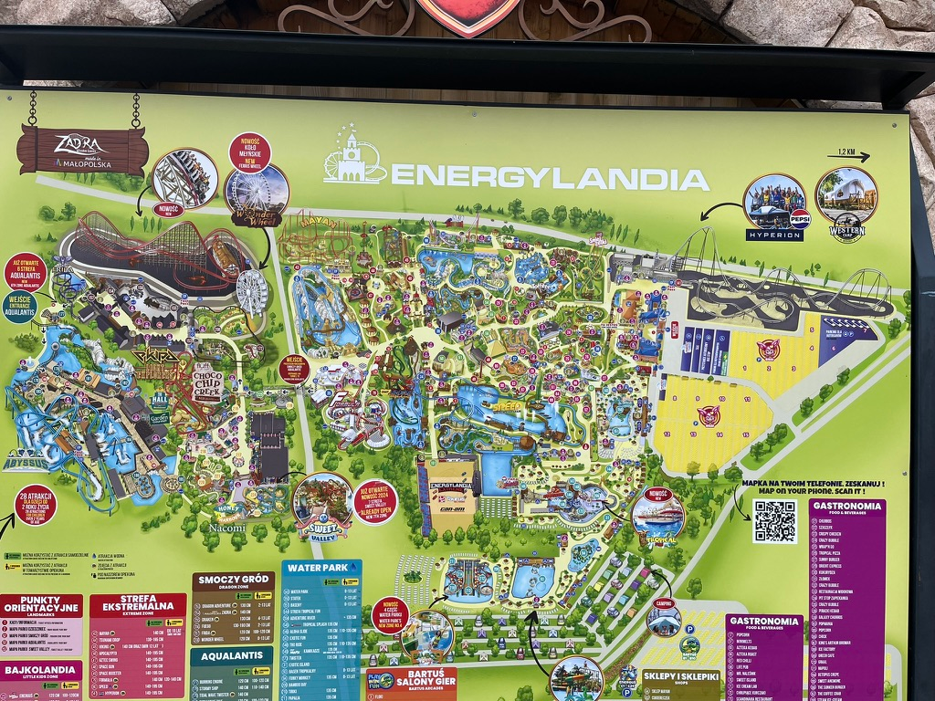 Large illustrated map of Energylandia theme park showing roller coasters, themed zones, water attractions, restaurants and visitor facilities across the park.