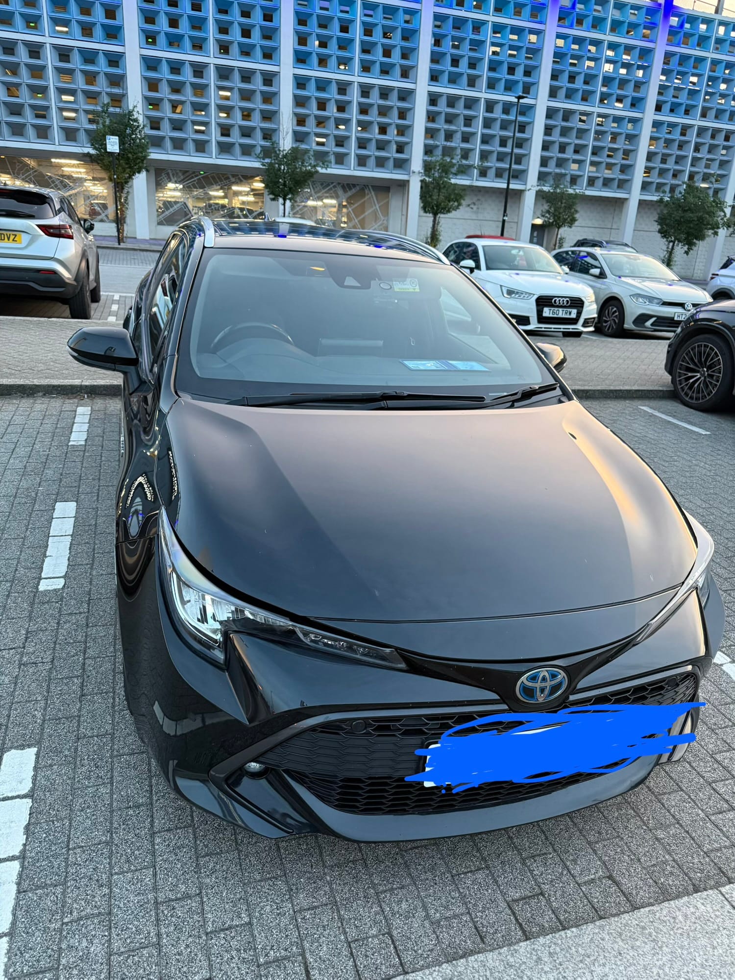 Black Toyota estate car parked outside a hotel in Milton Keynes.