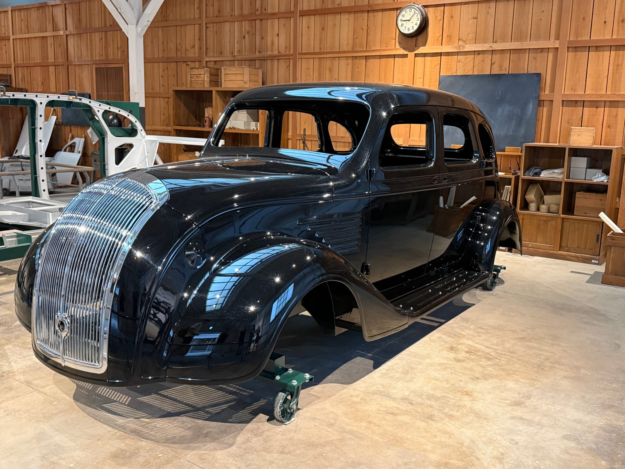 Body shell of an early Toyota passenger car on display at the Toyota Commemorative Museum of Industry and Technology, showing the streamlined design of the company's first automobiles.