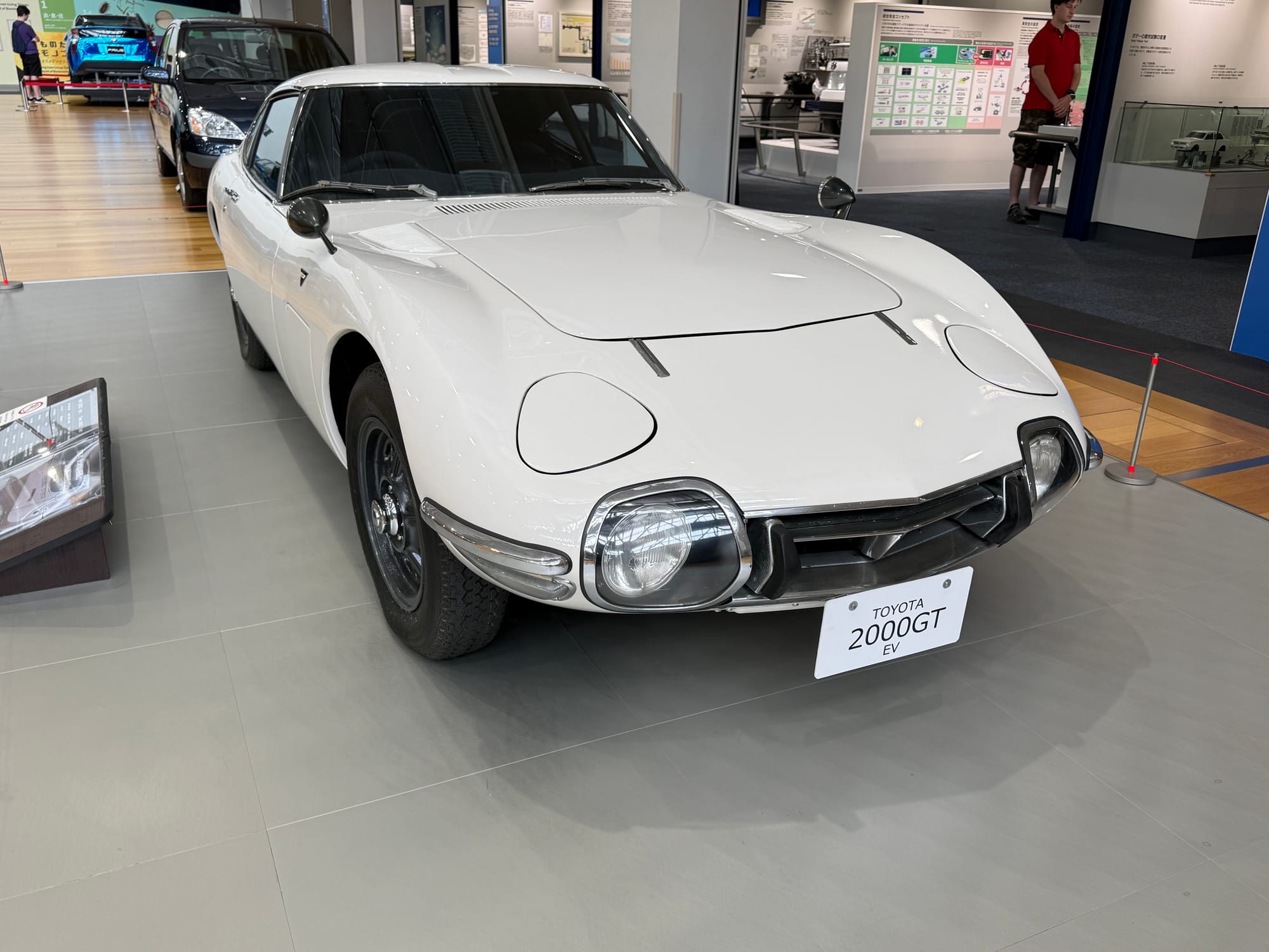Toyota 2000GT electric vehicle conversion on display at the Toyota Commemorative Museum, combining the iconic classic sports car design with a modern electric drivetrain.