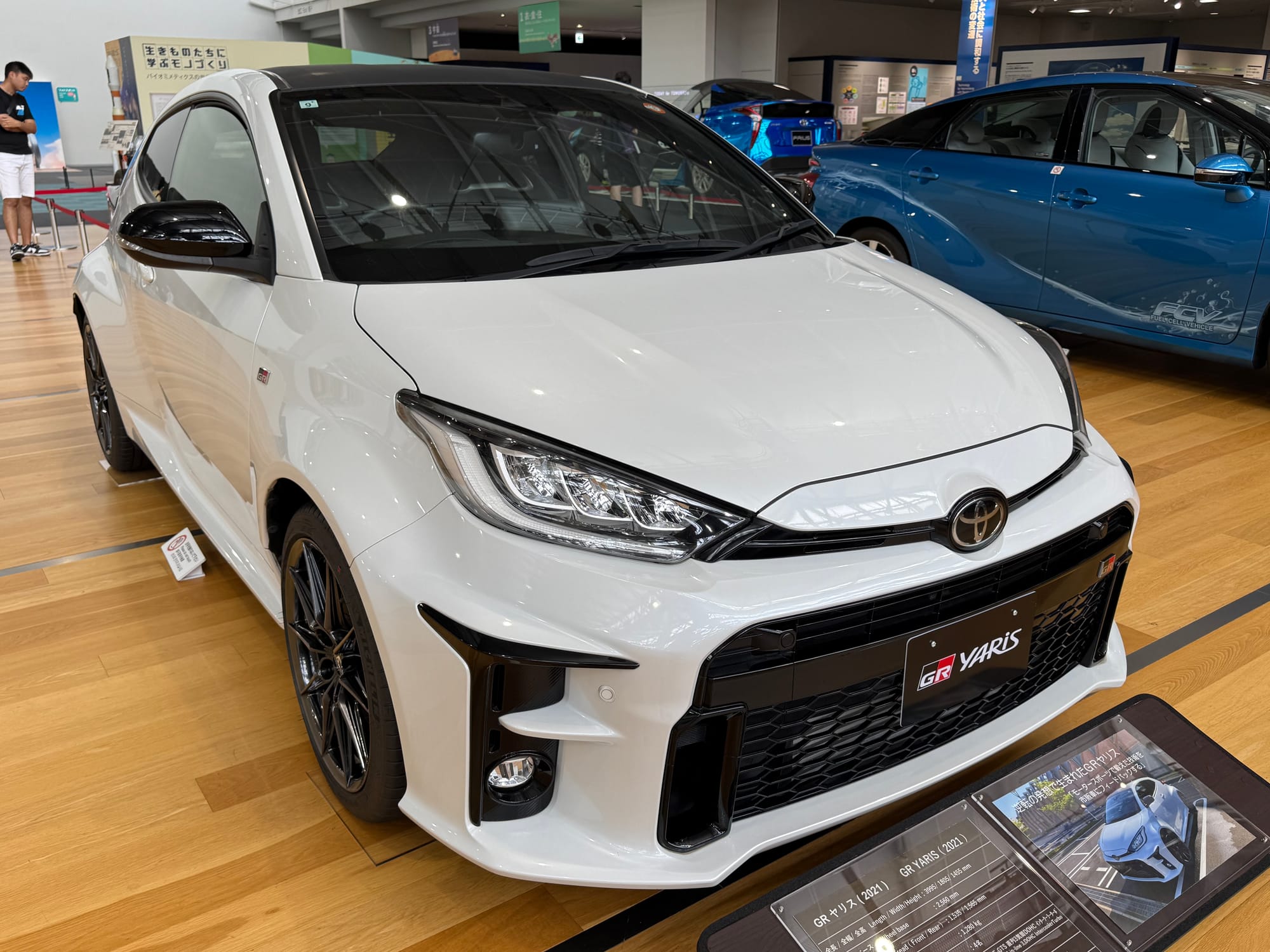 Toyota GR Yaris on display at the Toyota Commemorative Museum of Industry and Technology, featuring white bodywork, widened arches and rally-inspired performance styling.