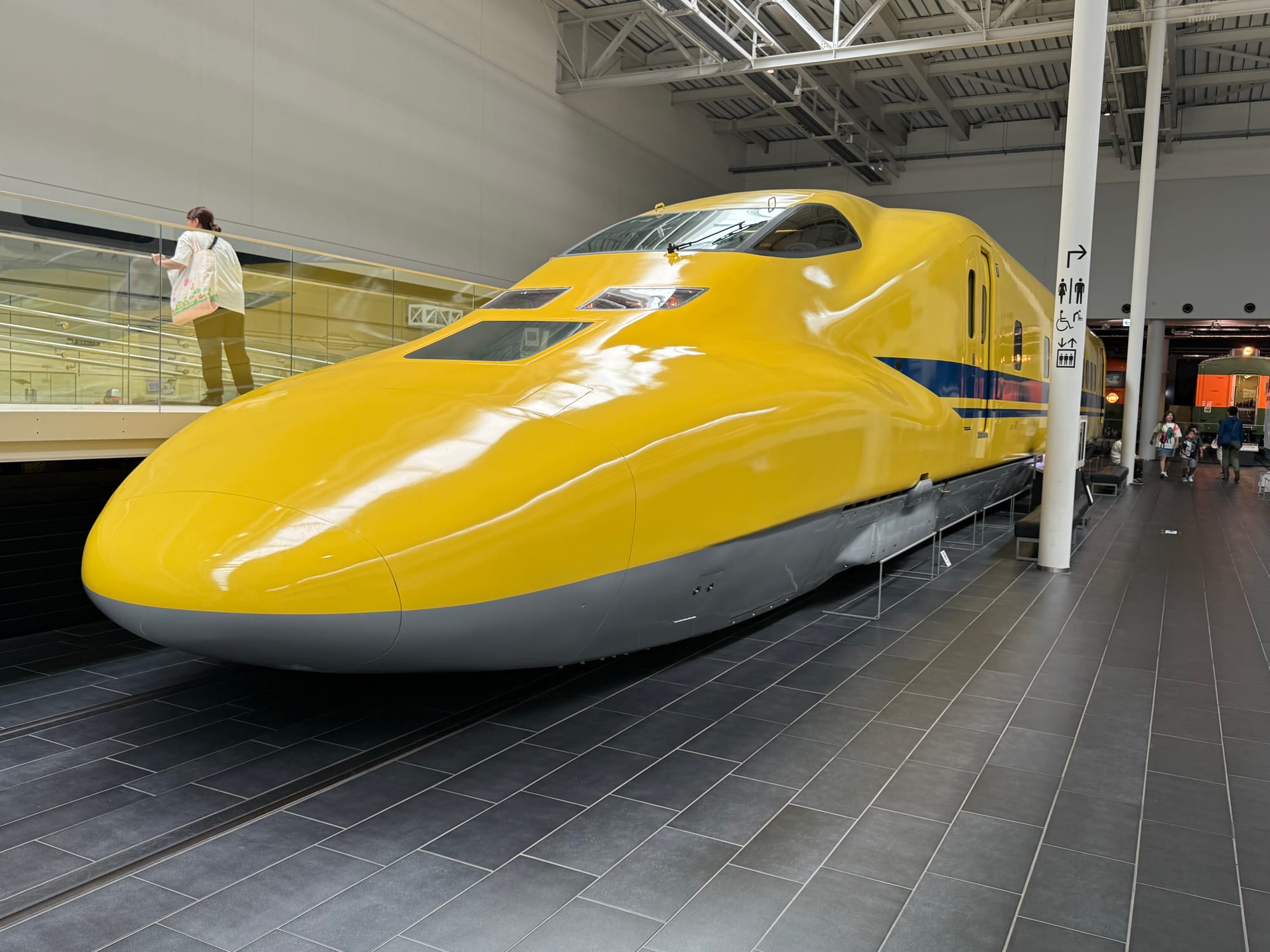 Doctor Yellow inspection Shinkansen displayed at the SCMAGLEV and Railway Park in Nagoya, featuring its bright yellow livery and distinctive streamlined nose.