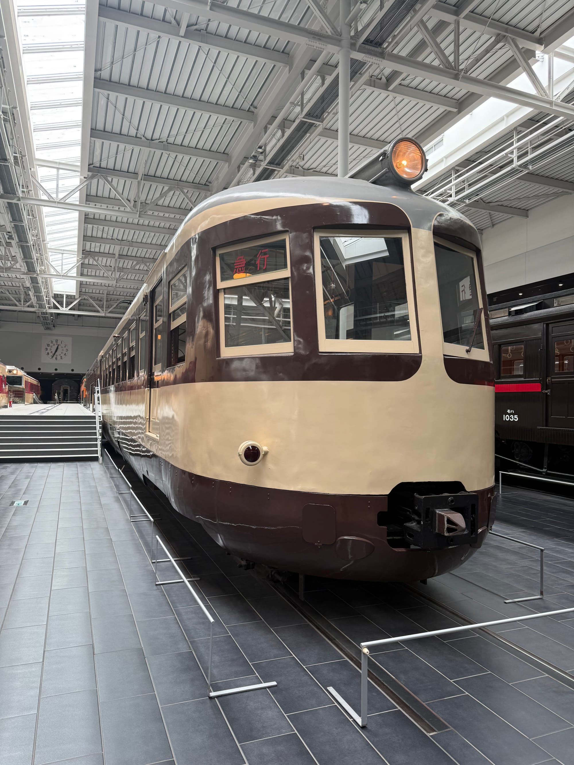 JNR Series 80 electric multiple unit displayed at the SCMAGLEV and Railway Park in Nagoya, featuring its distinctive cream and brown livery and rounded driving cab.