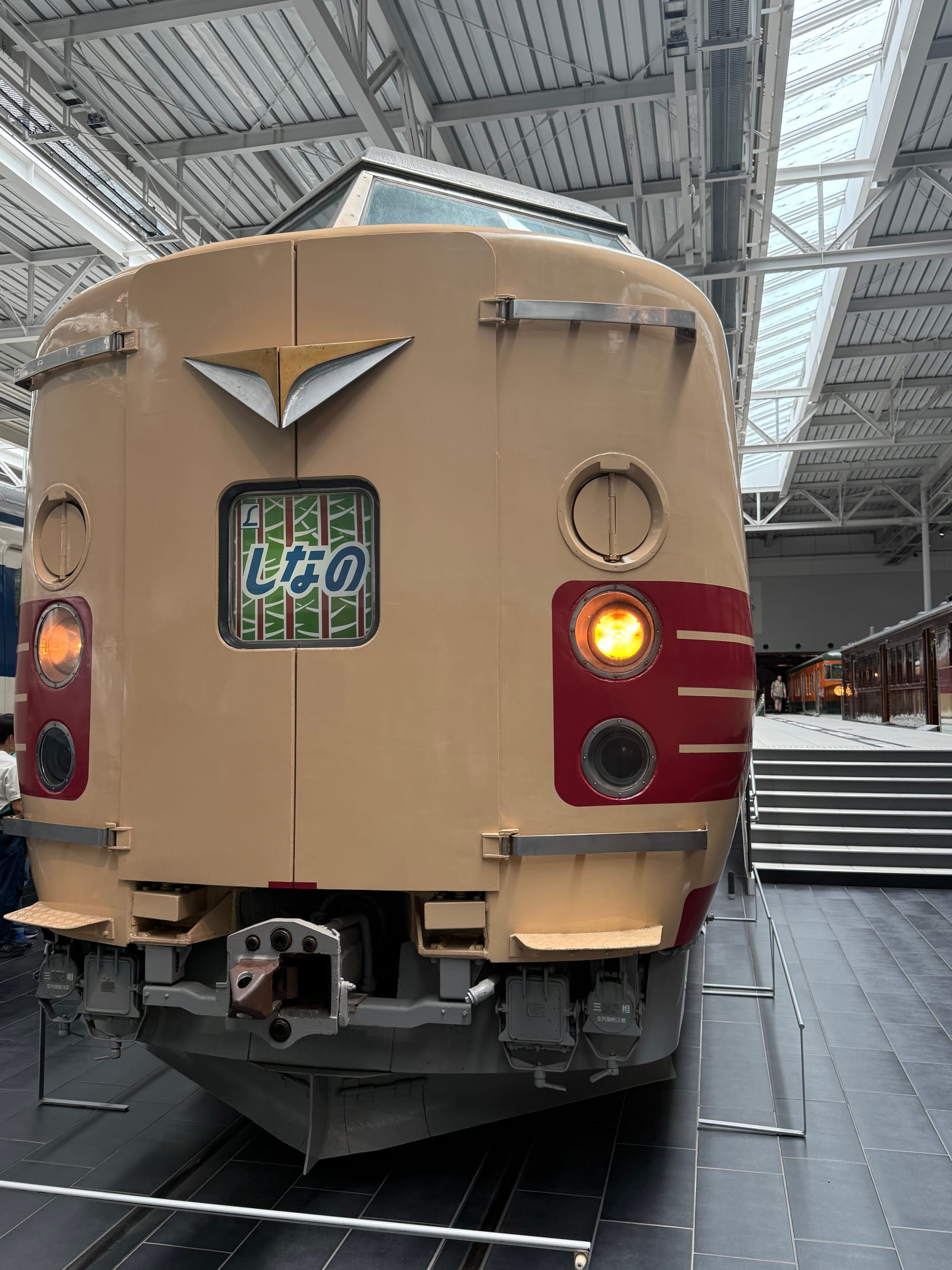 JNR 381 Series limited express train displayed at the SCMAGLEV and Railway Park in Nagoya, featuring its cream-and-red livery and destination blind showing Shinano.