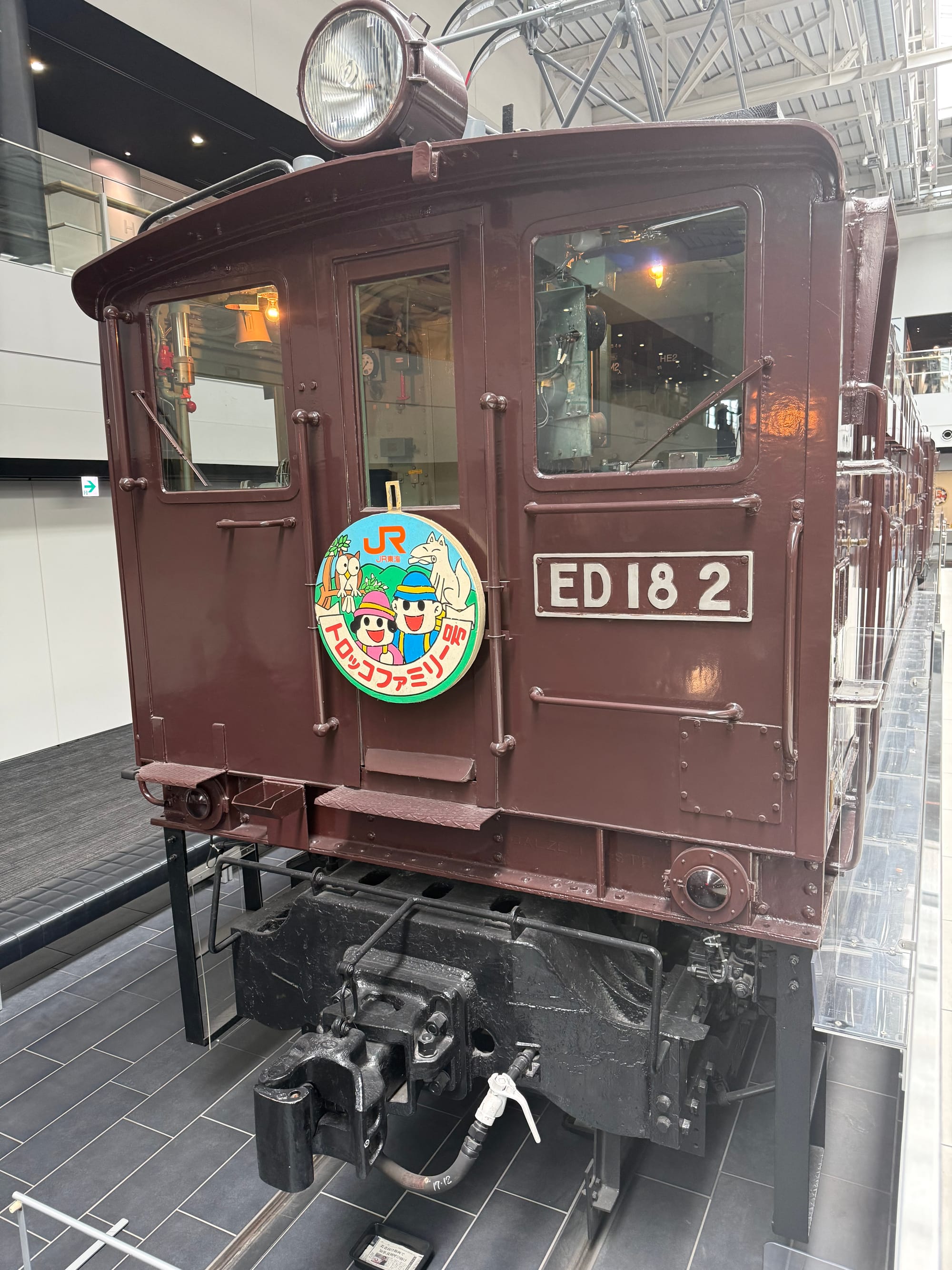 Rear cab of ED18 2 electric locomotive displayed at the SCMAGLEV and Railway Park in Nagoya, featuring brown bodywork, a pantograph and historic JR headboard.