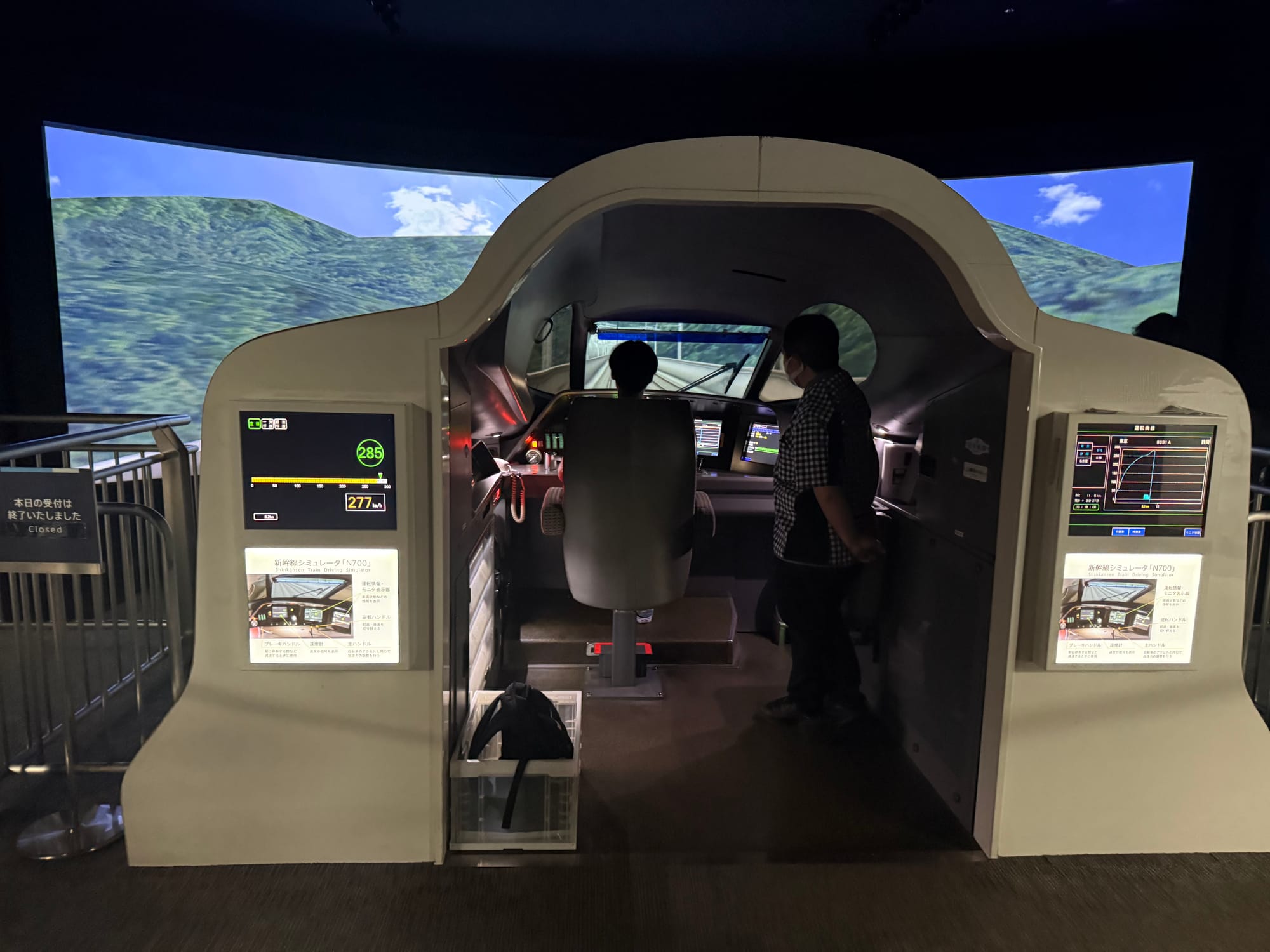 N700 Series Shinkansen driving simulator at the SCMAGLEV and Railway Park in Nagoya, recreating a train cab with immersive screens showing a high-speed railway route.