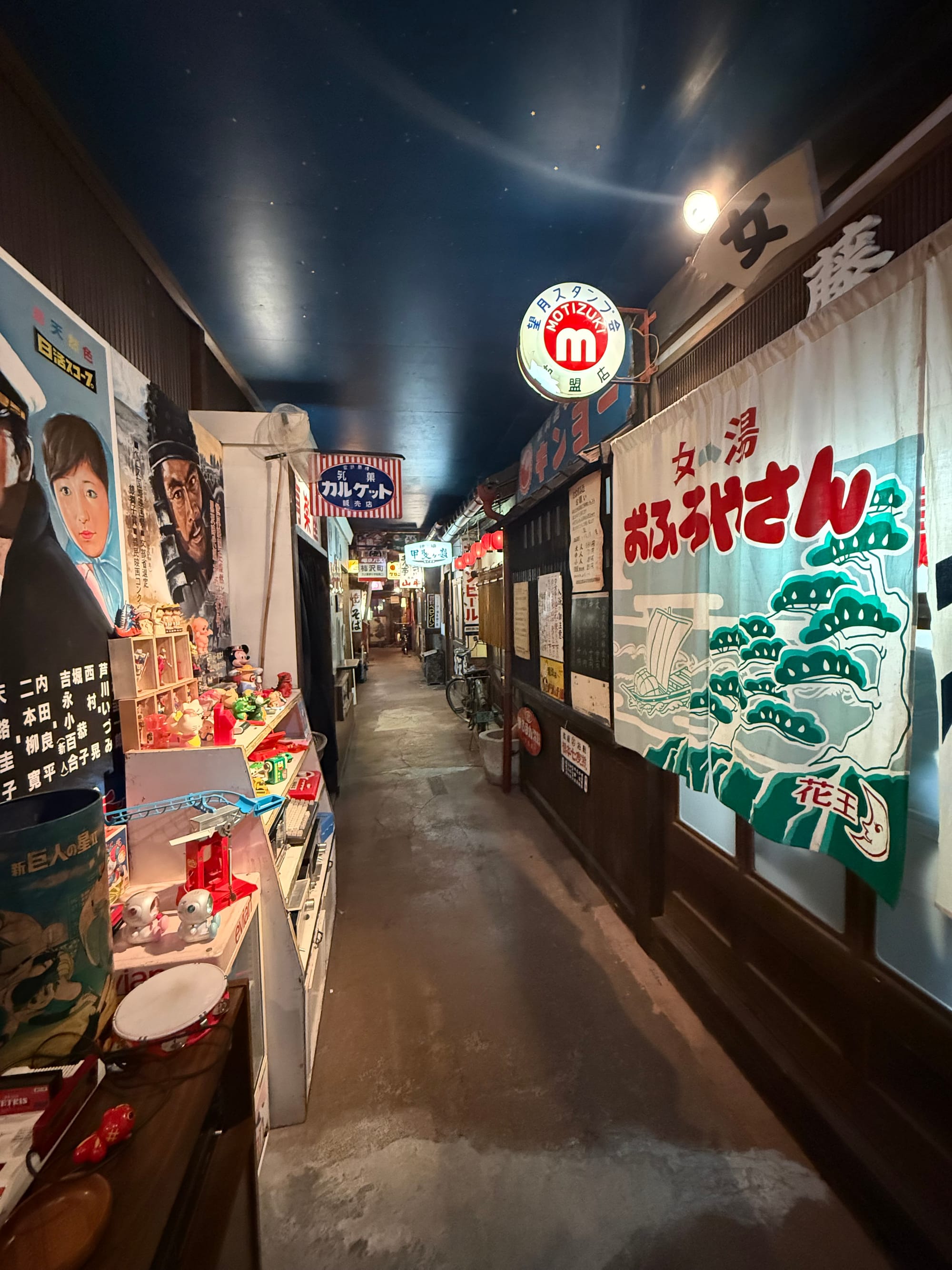 Recreated Showa-era shopping street inside the Takayama Showa-kan Museum, featuring vintage shopfronts, retro advertisements, nostalgic toys and period signage.