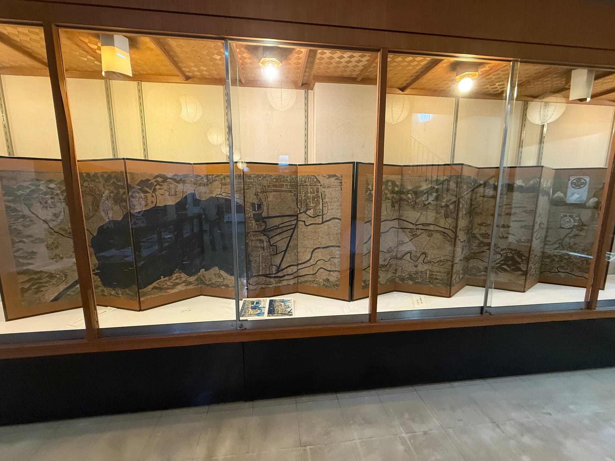 Historic folding screen displayed at Takashima Castle, depicting Lake Suwa, the castle grounds, surrounding settlements and the landscape of the Suwa region in detailed artwork.