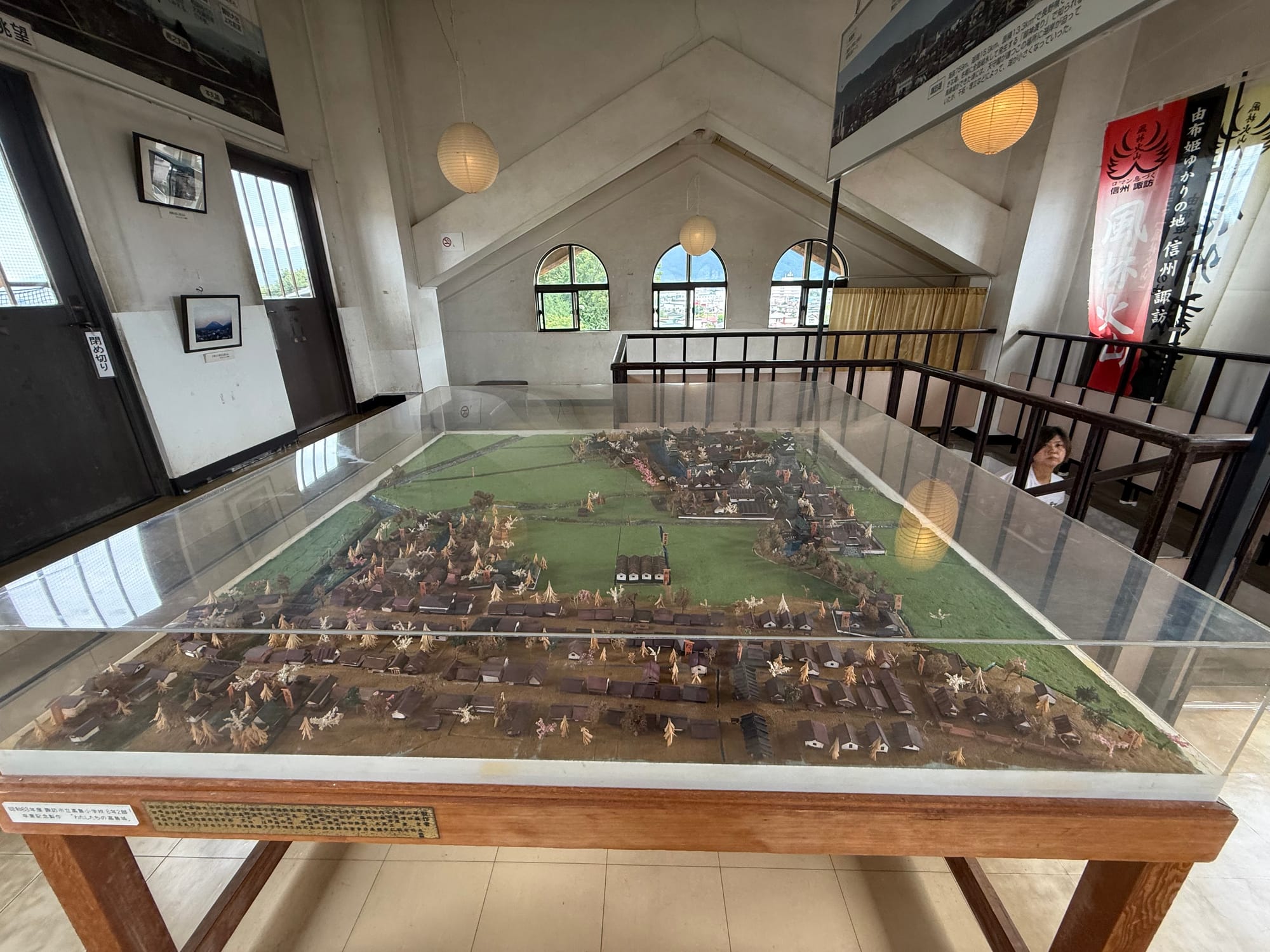 Scale model of Takashima Castle and its surrounding castle town displayed inside the castle museum, showing buildings, defensive walls, moats and nearby settlements.