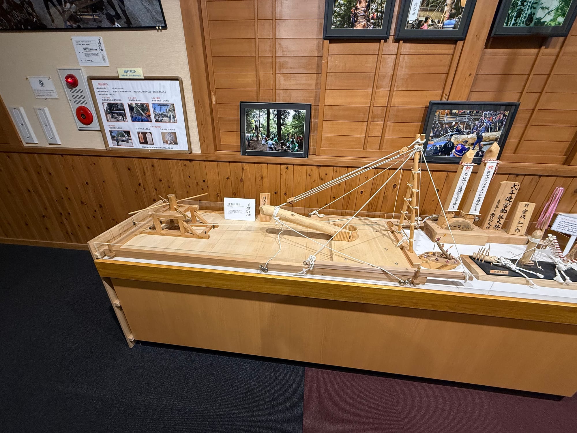 Scale model at Onbashira-kan Yoisa showing the rigging and support structures used to control an Onbashira log before it is released down a steep mountainside.