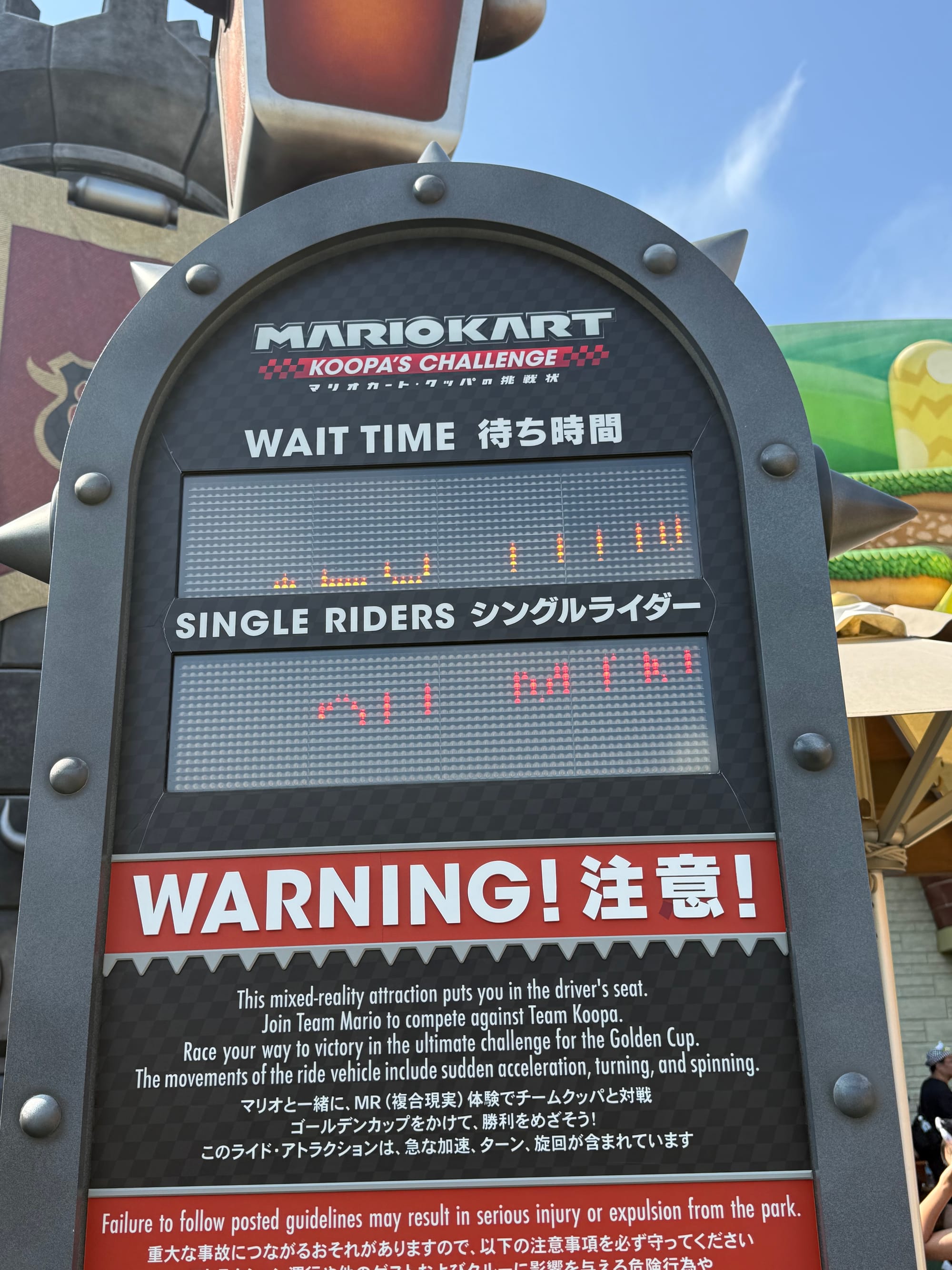 Wait time sign for Mario Kart: Koopa's Challenge in Super Nintendo World at Universal Studios Japan, showing attraction information, single rider details and ride warnings.