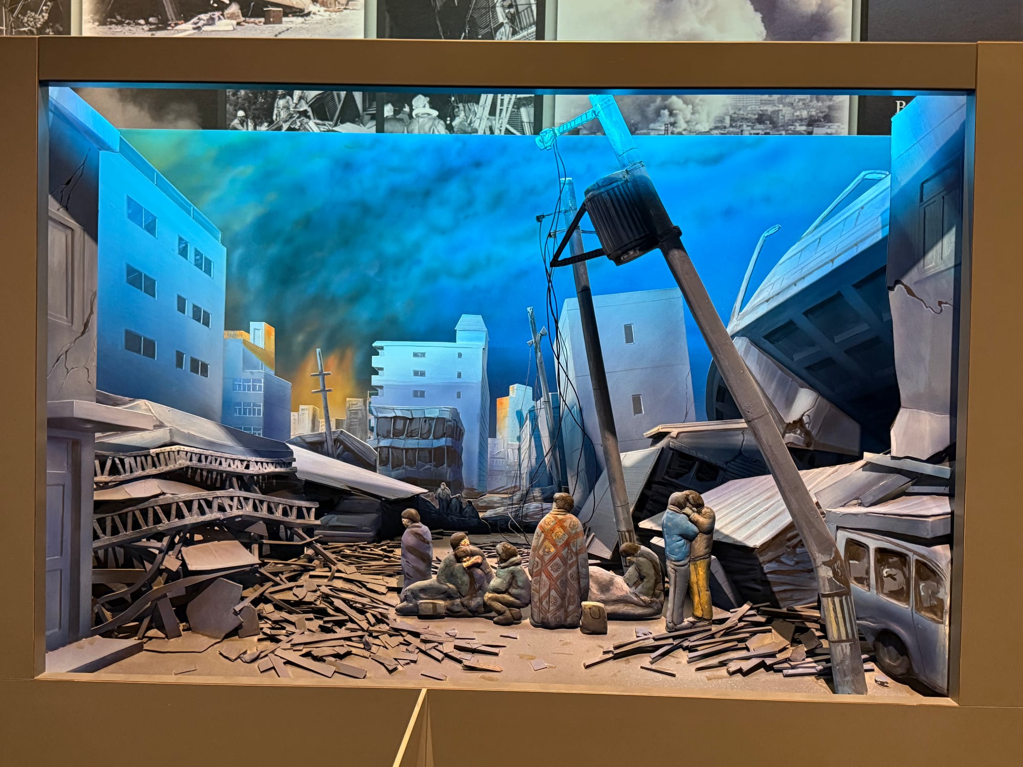 Diorama at the Great Hanshin-Awaji Earthquake Memorial depicting widespread earthquake destruction, with collapsed buildings, damaged infrastructure, debris-filled streets and displaced residents.