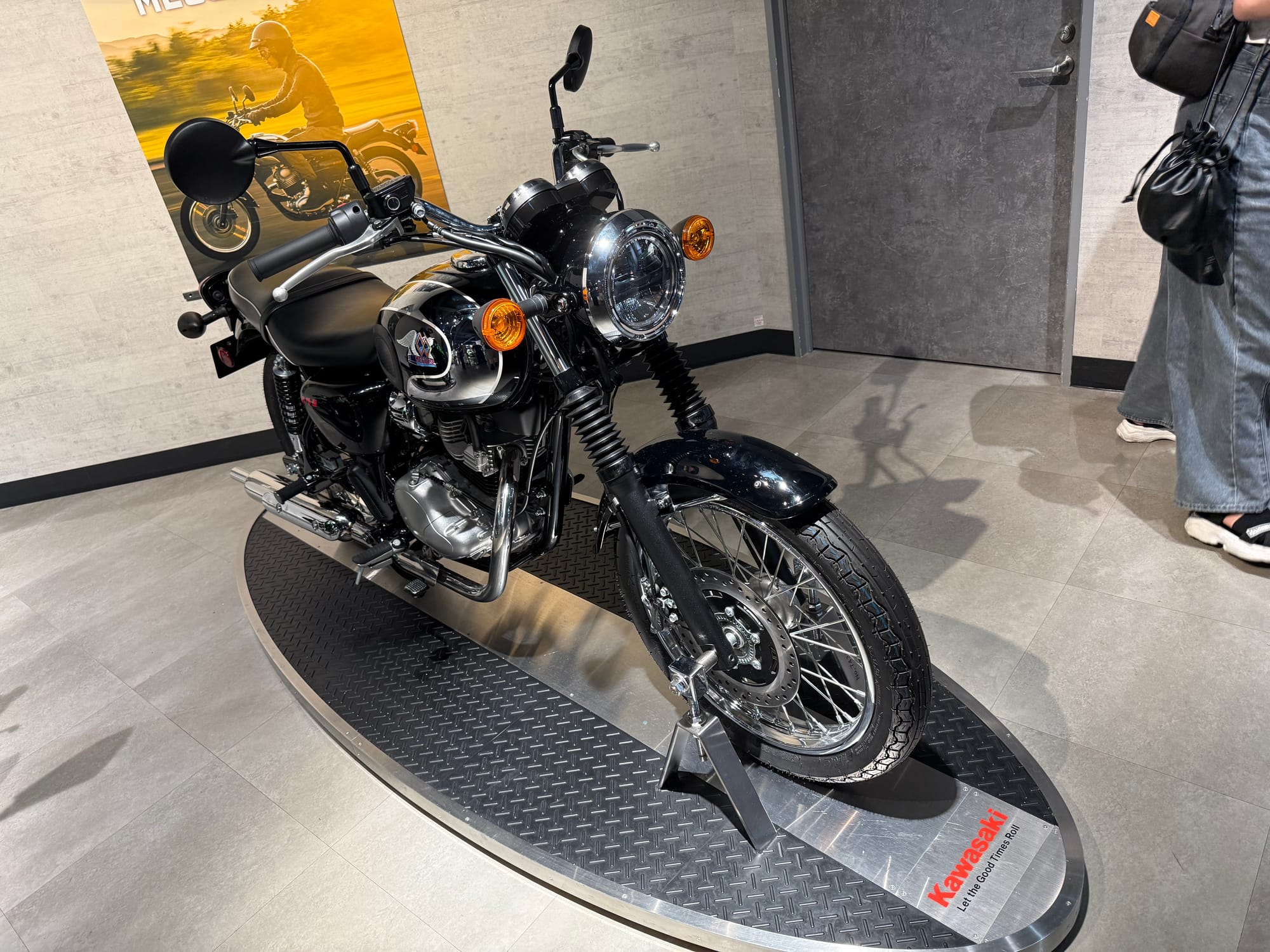 Kawasaki Meguro S1 motorcycle displayed at Kawasaki Good Times World in Kobe, featuring classic styling, wire-spoke wheels, chrome detailing and a black-and-silver fuel tank.
