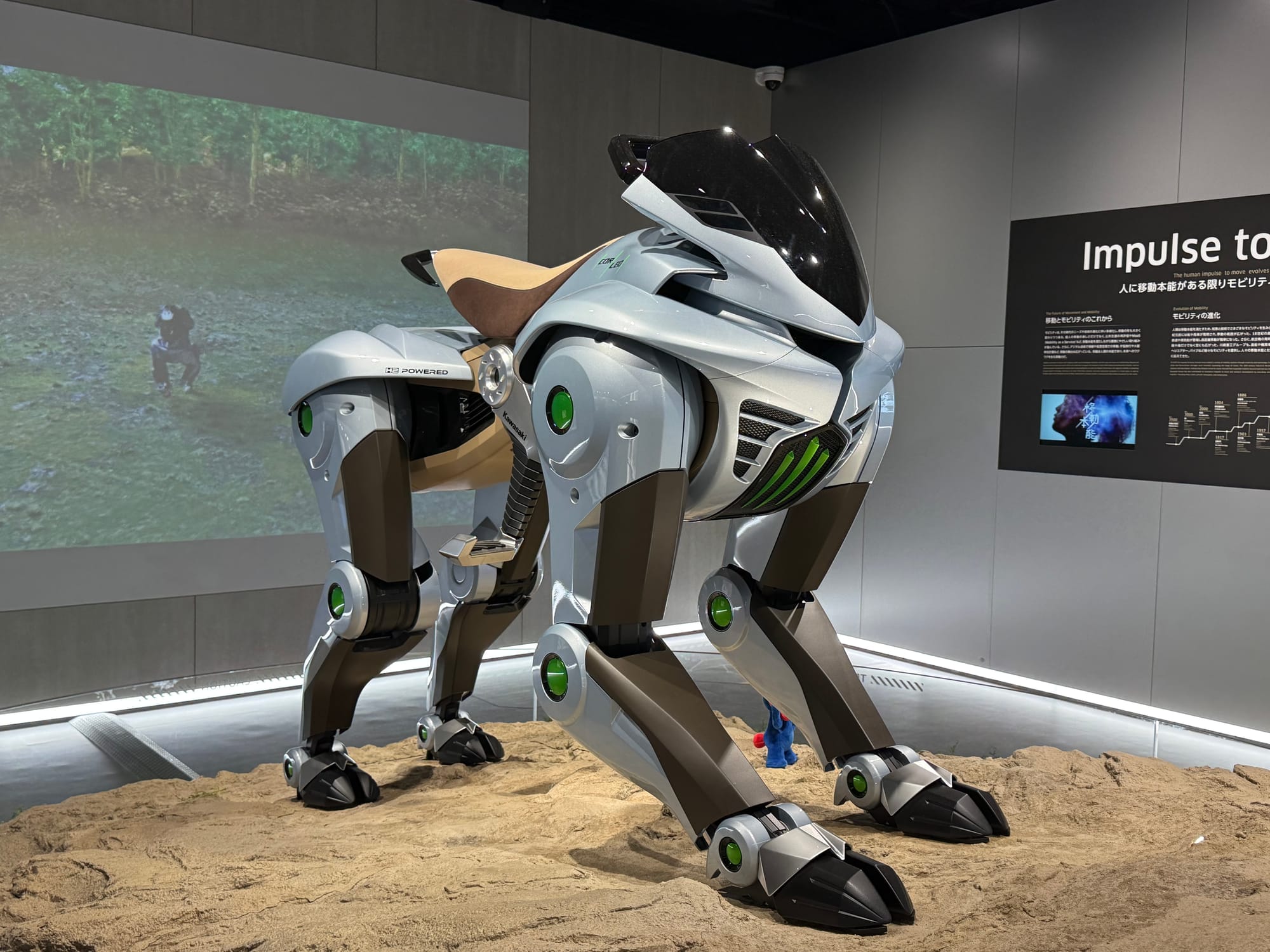 Kawasaki CORLEO quadruped mobility concept displayed at Kawasaki Good Times World, featuring four robotic legs, a saddle-style seat and futuristic off-road design.