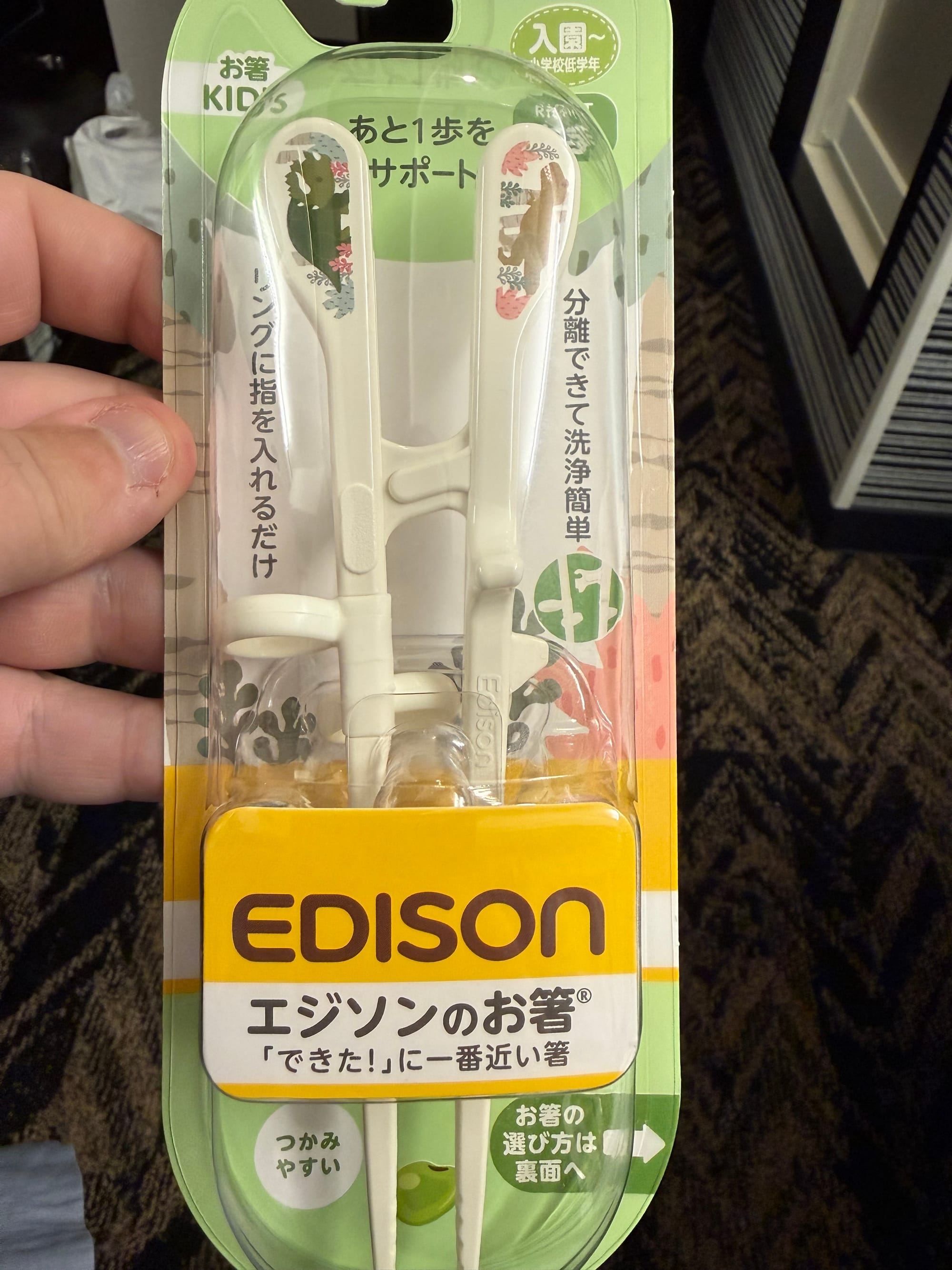 Edison training chopsticks for children displayed in retail packaging, featuring finger loops and a hinged design that helps young users learn proper chopstick technique.