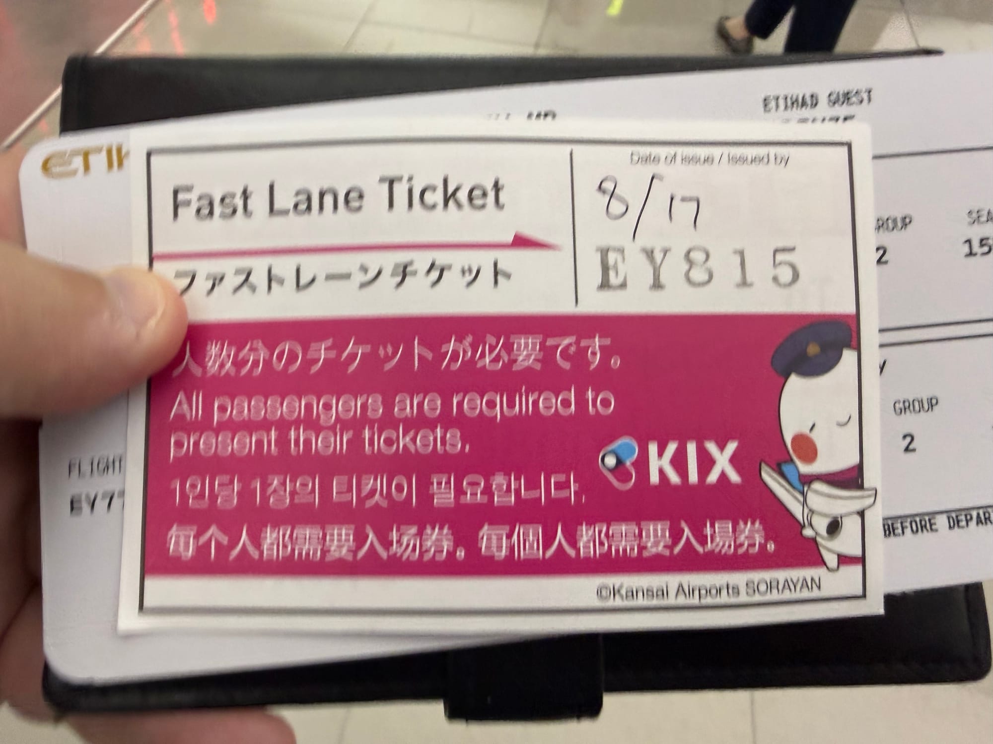 Fast Lane Ticket for Kansai International Airport (KIX) held in front of a boarding pass, providing priority access through airport security before departure.