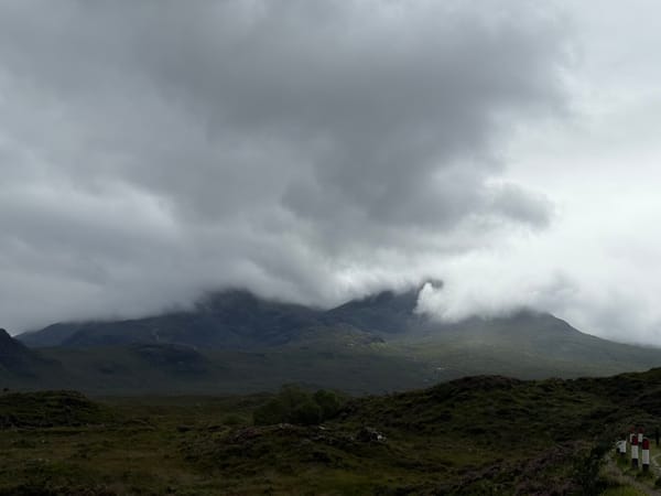 Misty mountains on the Isle of Skye beneath dark storm clouds.